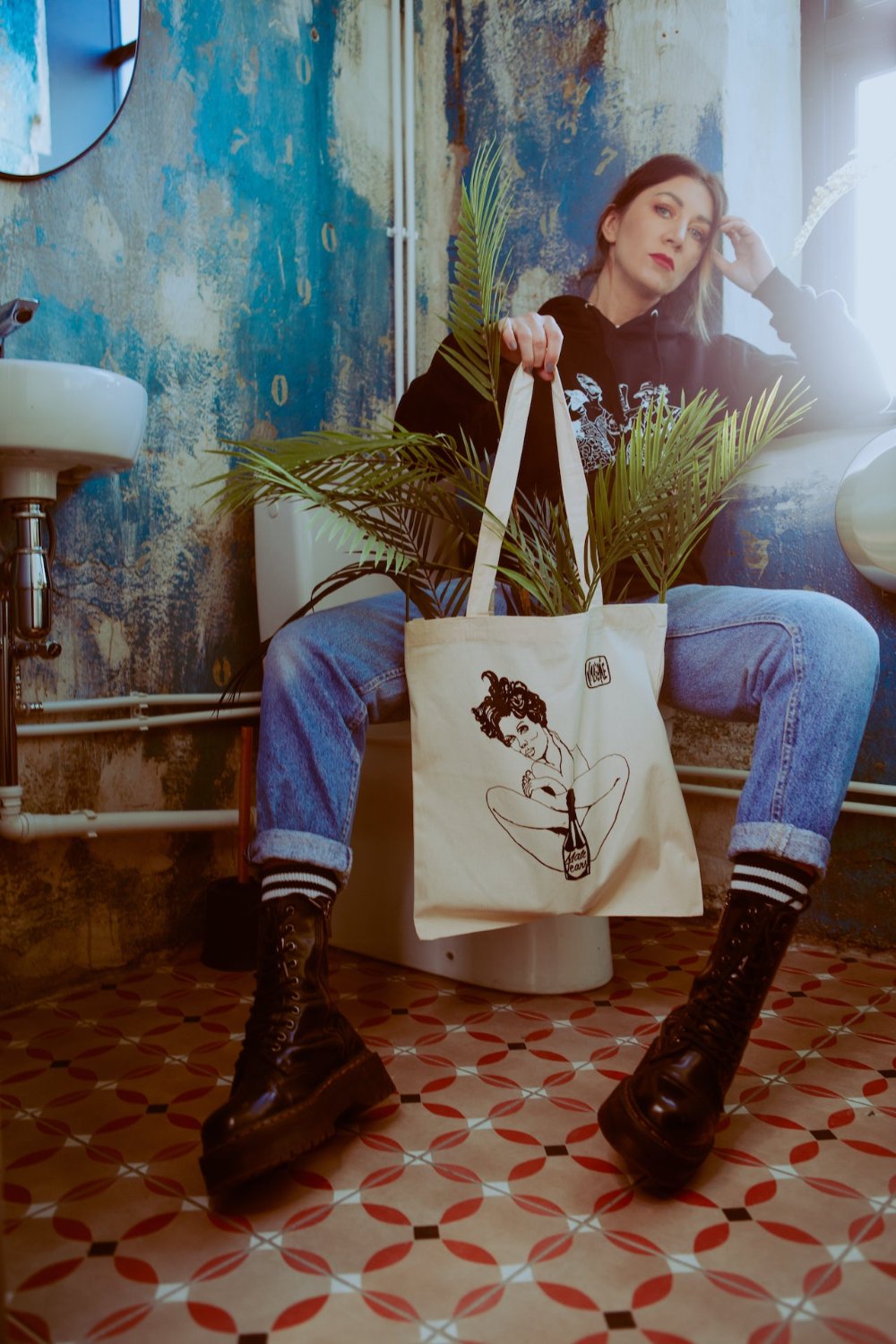 Model wearing the “Male Tears” Natural Tote Bag, displaying the eco-friendly, stylish accessory in use